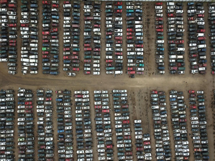 many cars are parked in a lot together