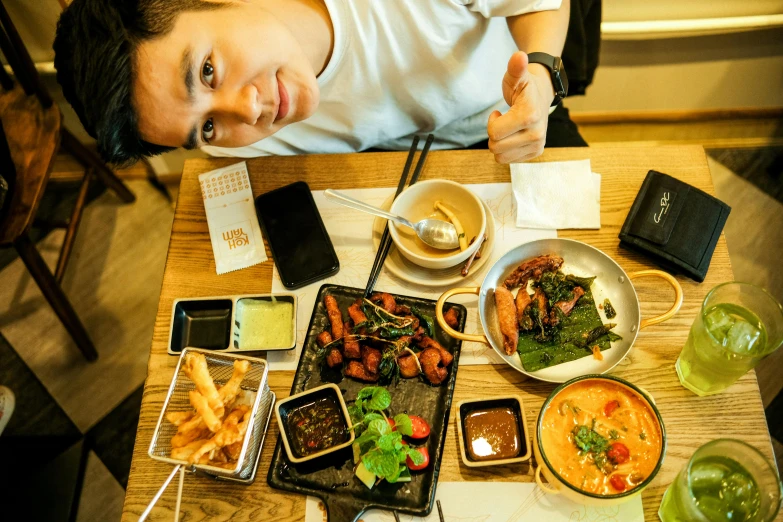 a person sitting at a table with some food