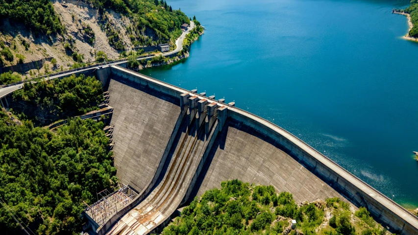 a view of the side of a dam with water at the bottom