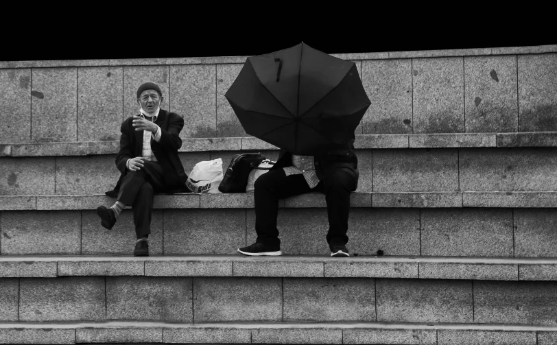 the man and woman are sitting on the steps