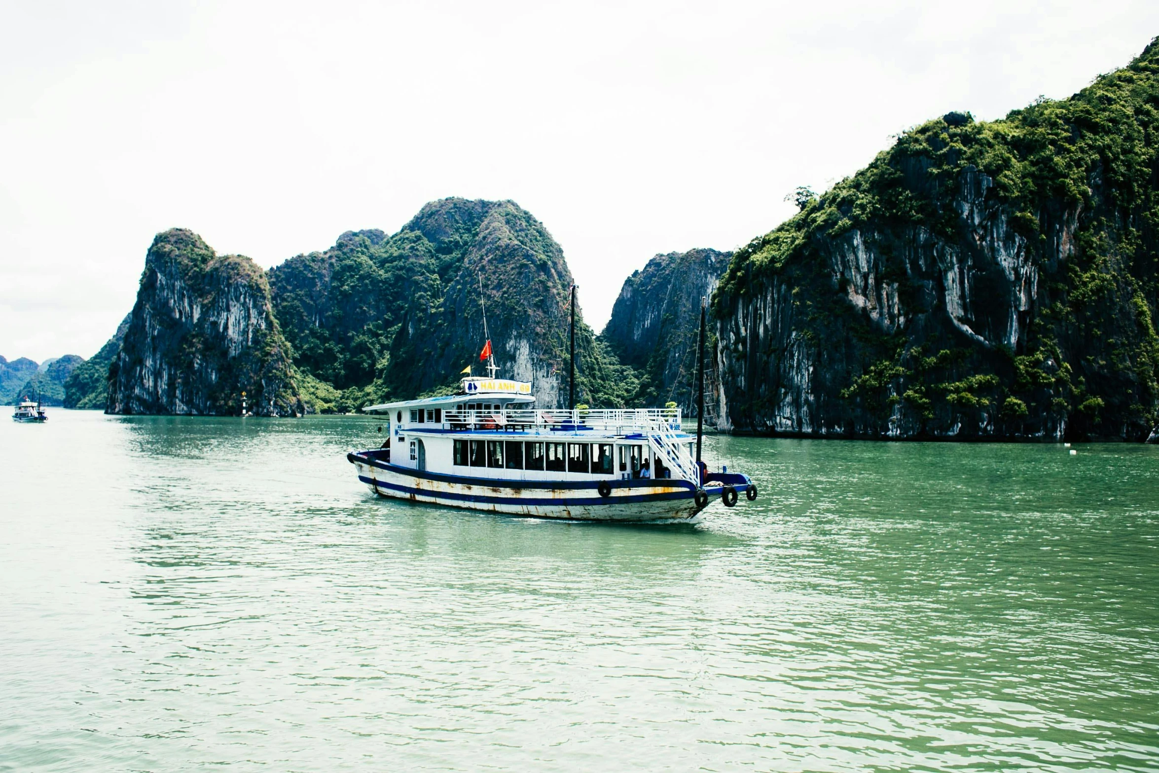 the water is crystal green and full of boats