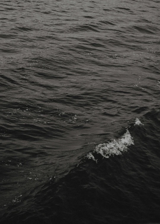 a man riding a board on top of a wave