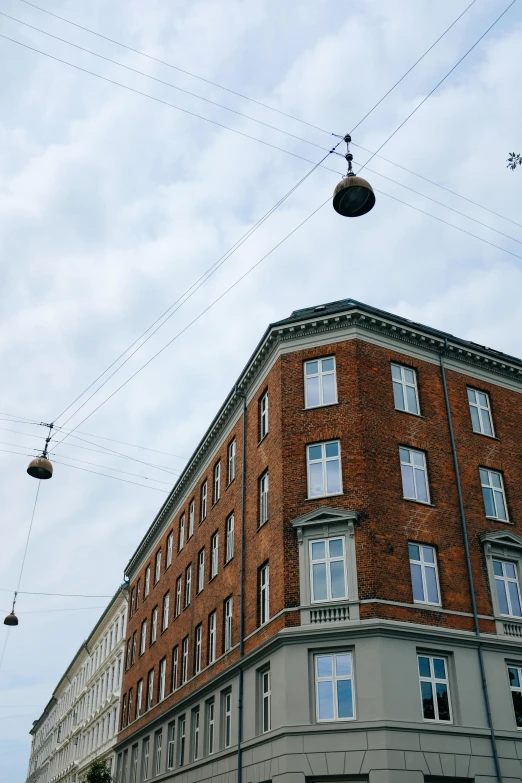 two wires running across the sky and the building