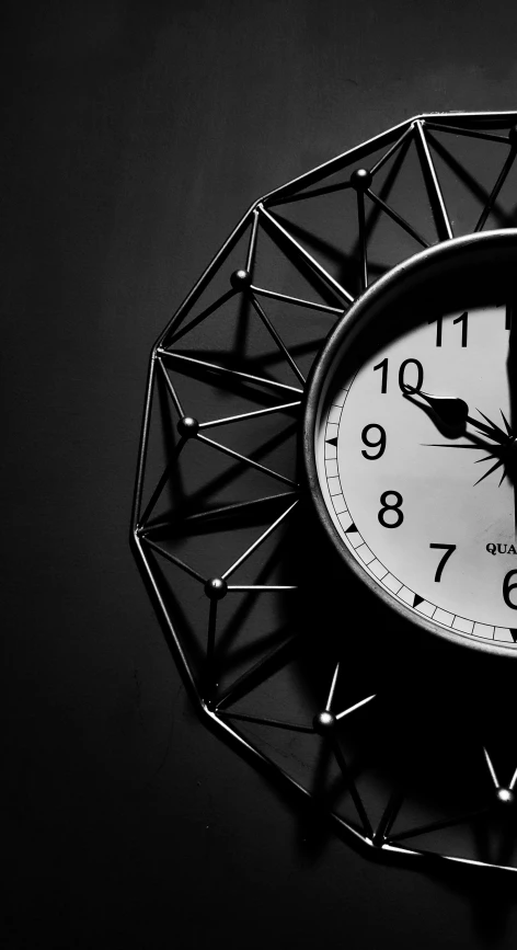 a black clock with white numbers and a black background