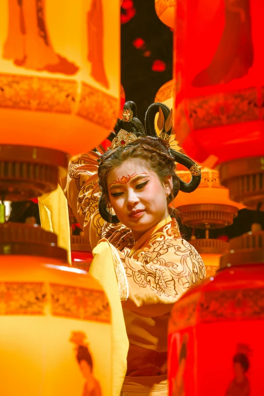 a person dressed in chinese clothing next to a red and yellow wall