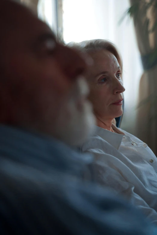 a woman is sitting in a chair and looking off into the distance