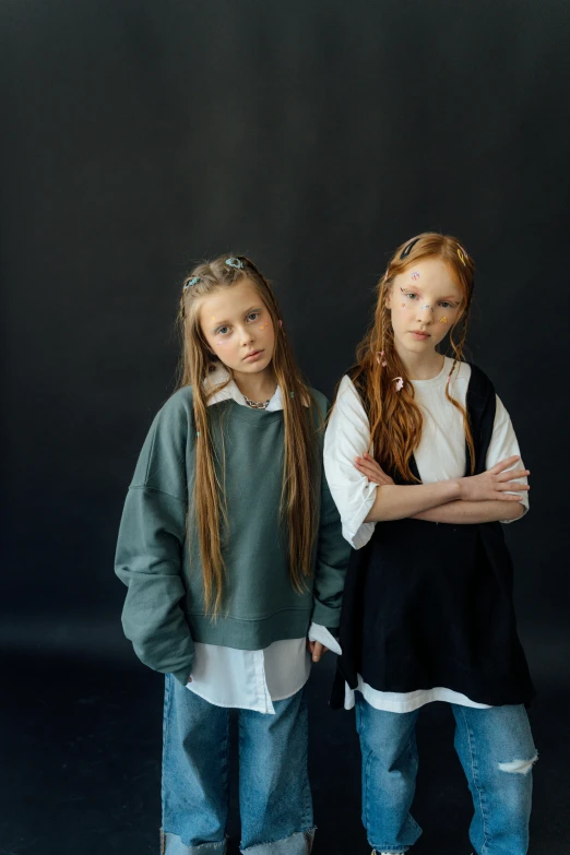 two girls are dressed up with long hair