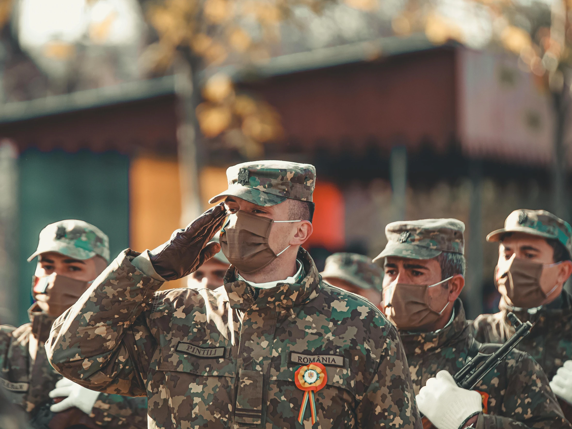 many military men are wearing face masks and marching