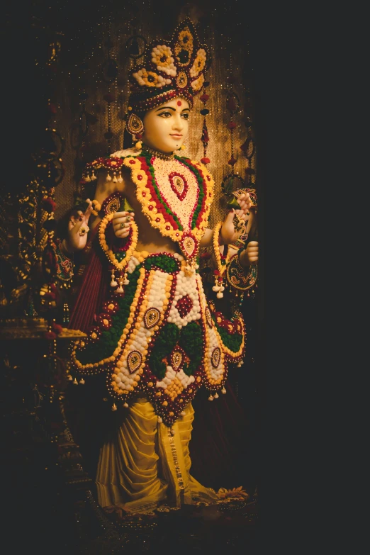 the idol is decorated with gold and green