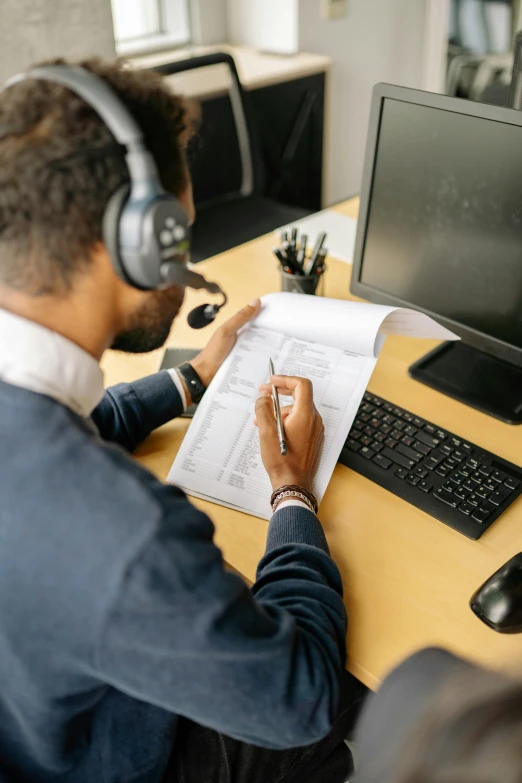 a man that is sitting in front of a desk