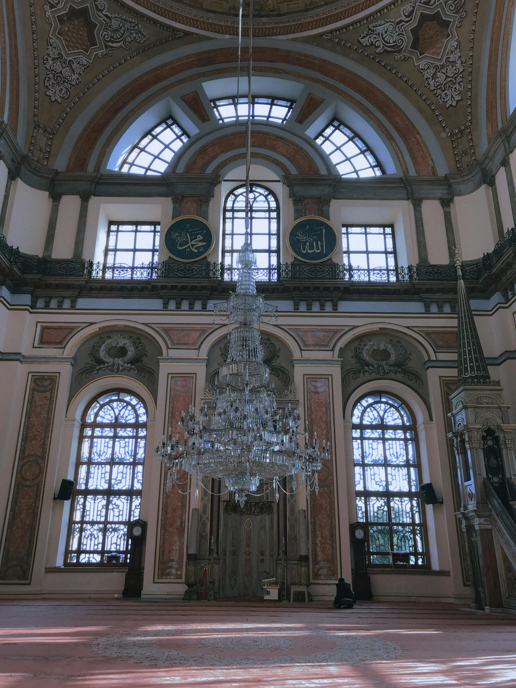 a fancy building has a crystal chandelier and many windows