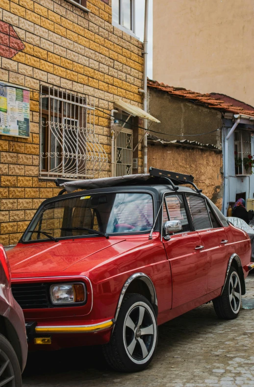 a car parked in front of a yellow brick building