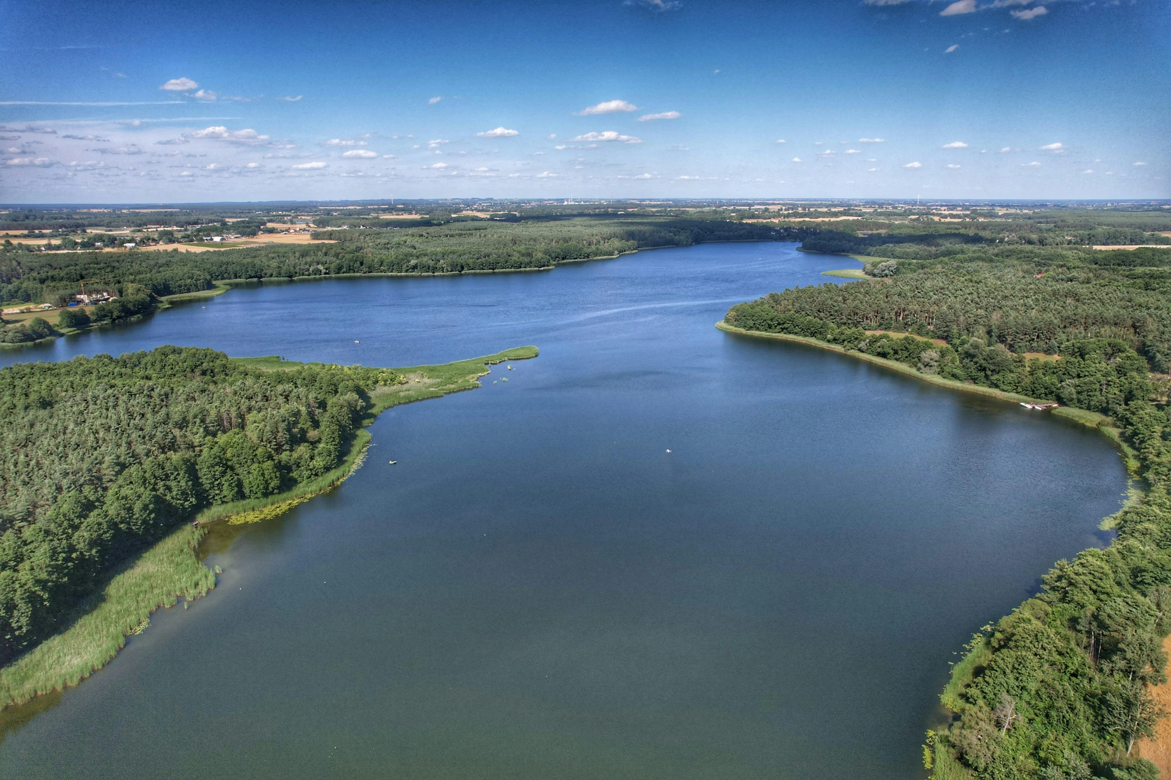 water is surrounded by trees and some other land