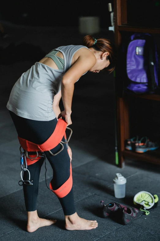 a woman who has a broken knee, is bent over