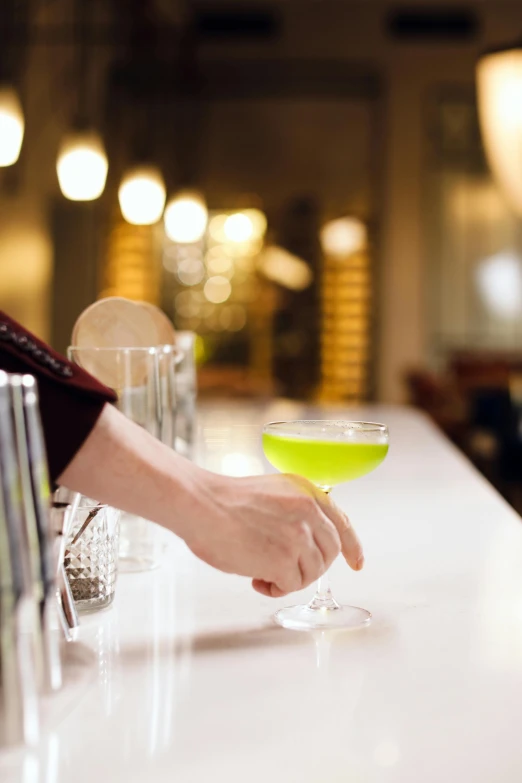 a person holding a glass with a beverage