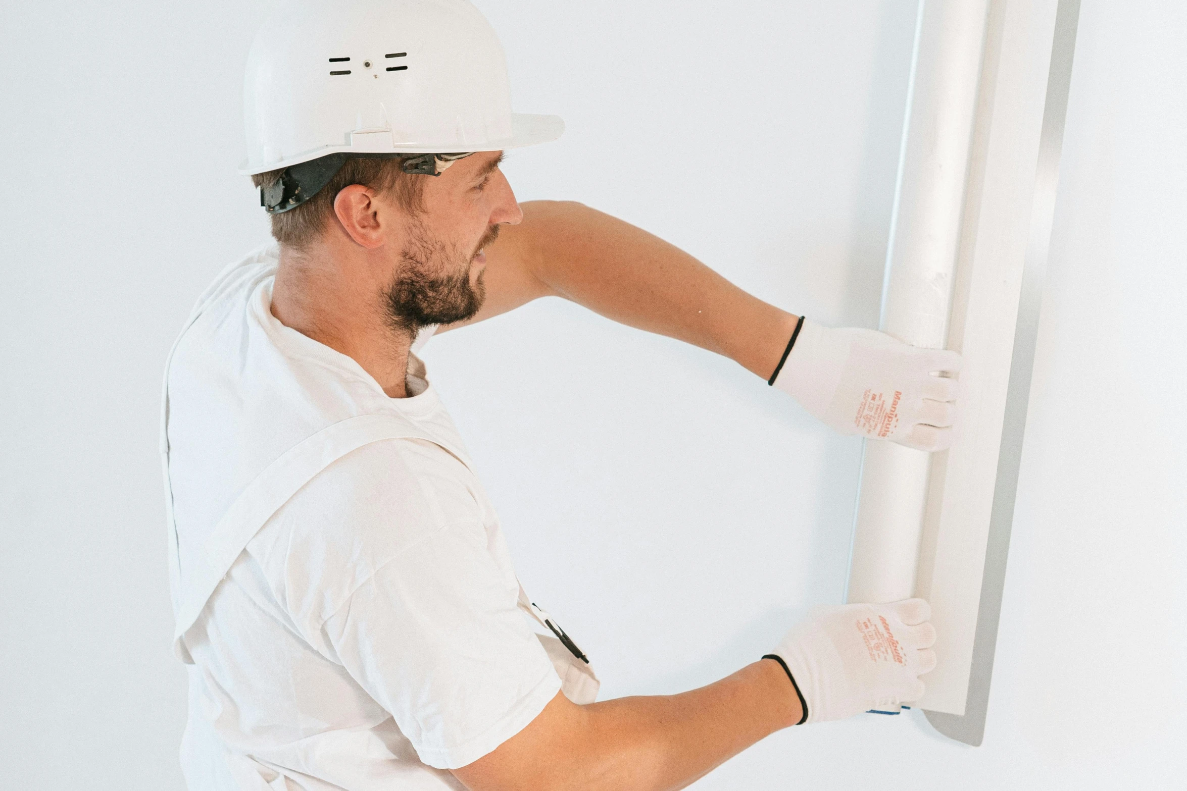 a person holding up an object in front of a wall