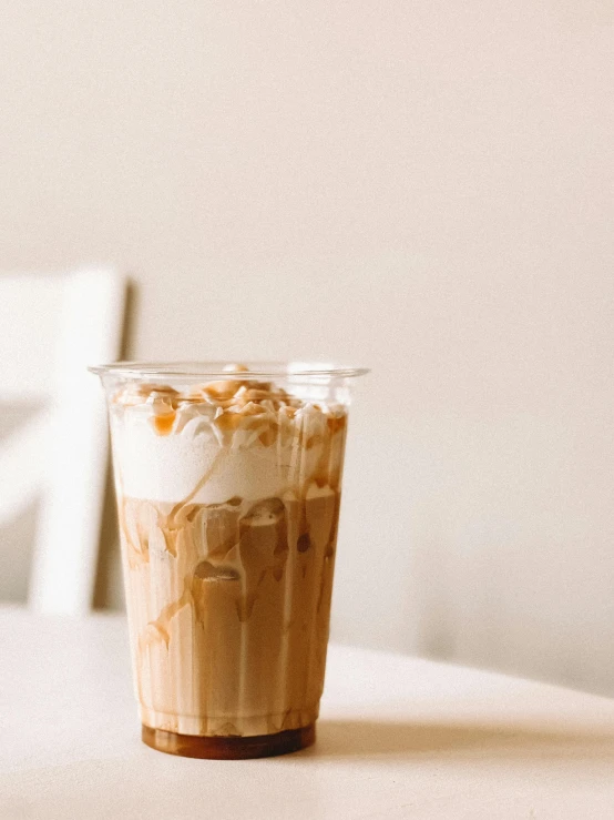 a glass with a cup of coffee and some nuts in it