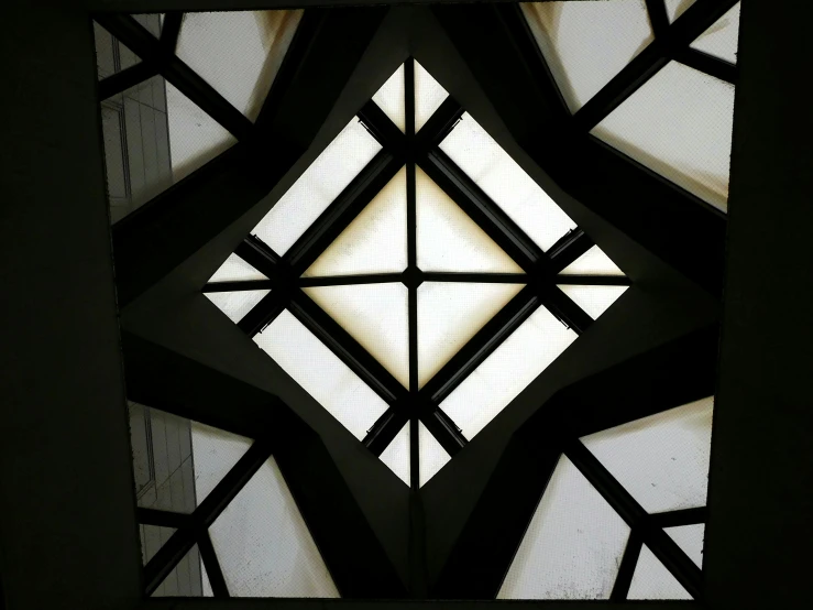 a dark view of an intricately designed window