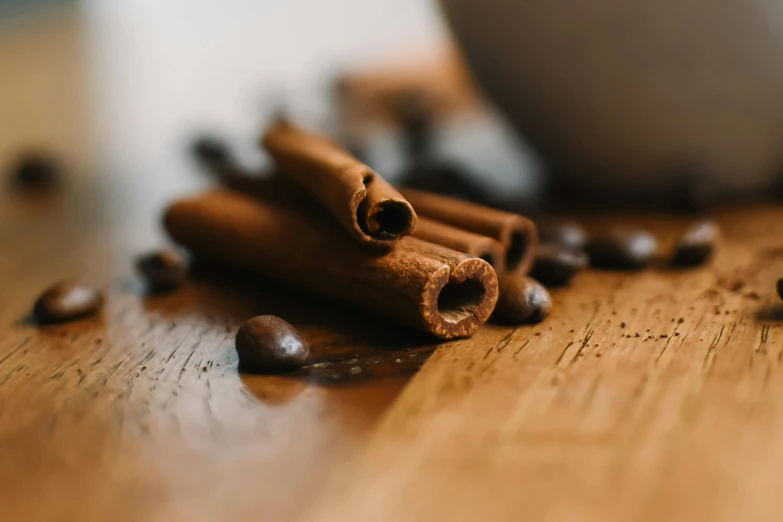 cinnamon sticks and coffee beans are on the table