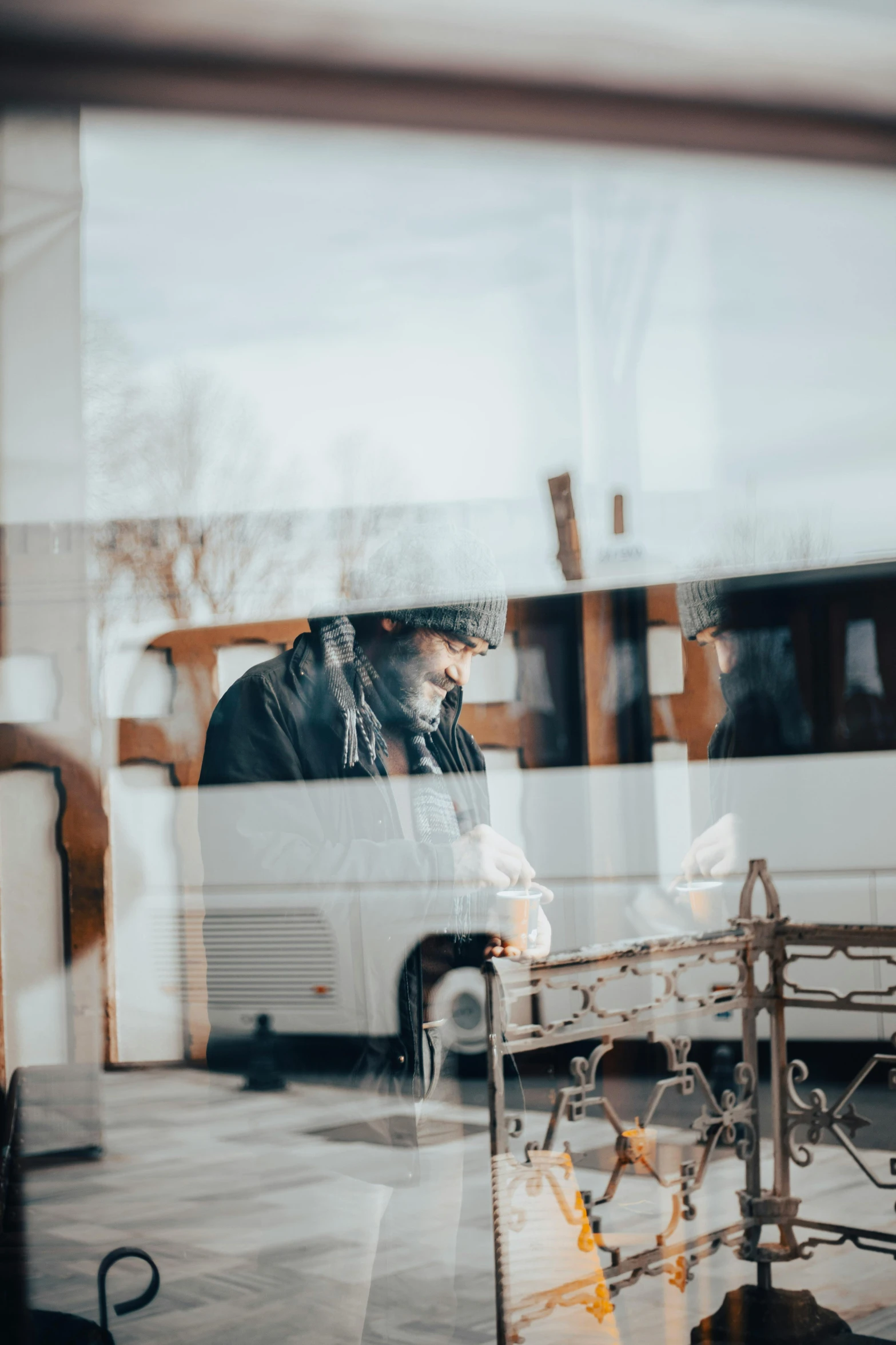 a man is sitting at a table while on the phone