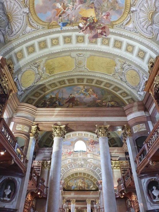 inside the lobby of the building with elaborate art work on the ceiling