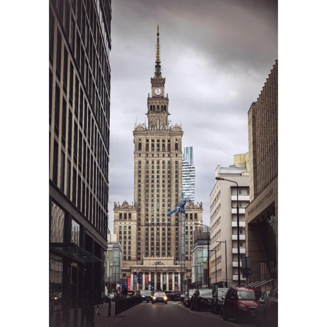 a large building towering over a city near tall buildings