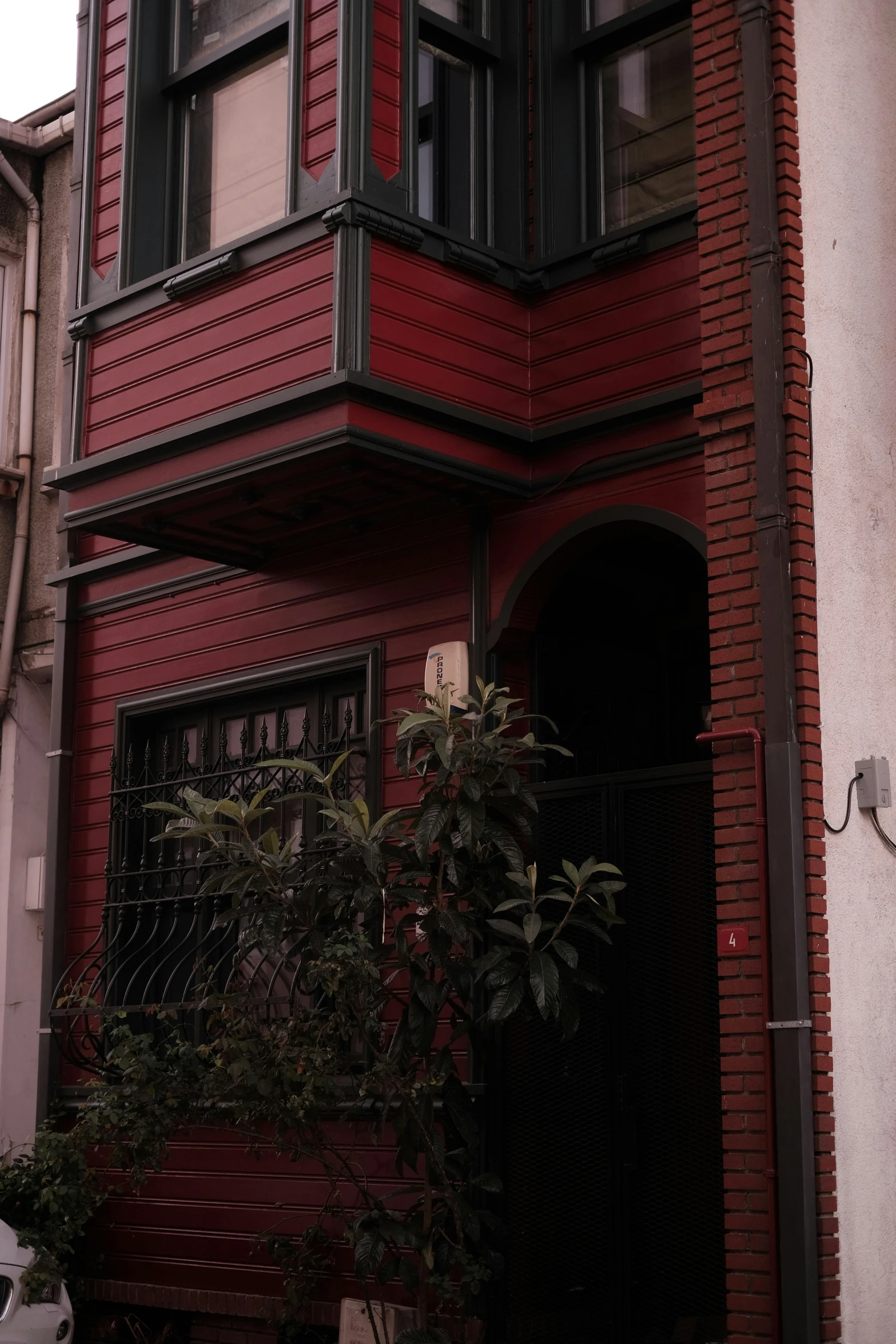 a red house with windows and gate