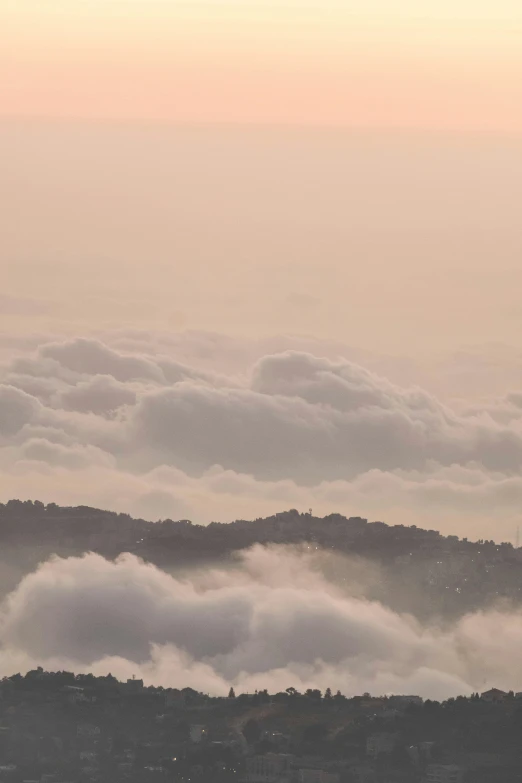 the view from the top of a mountain is covered in fog