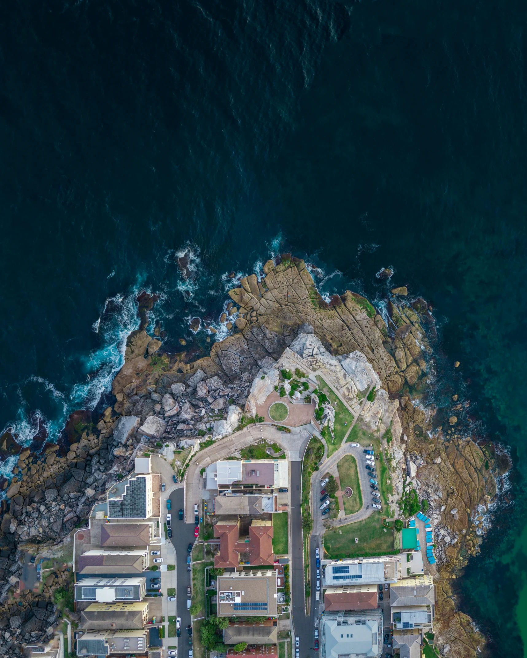 an aerial view of some buildings near the water