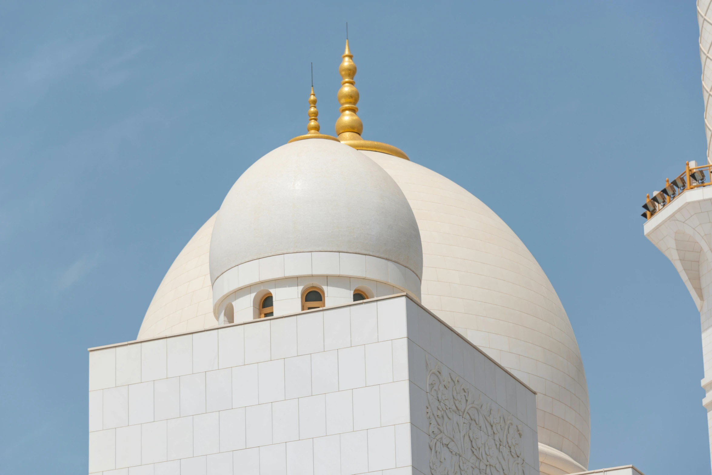 a white and yellow building is shown with a clear blue sky