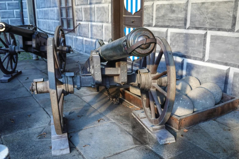 a large cannon leaning up against a building