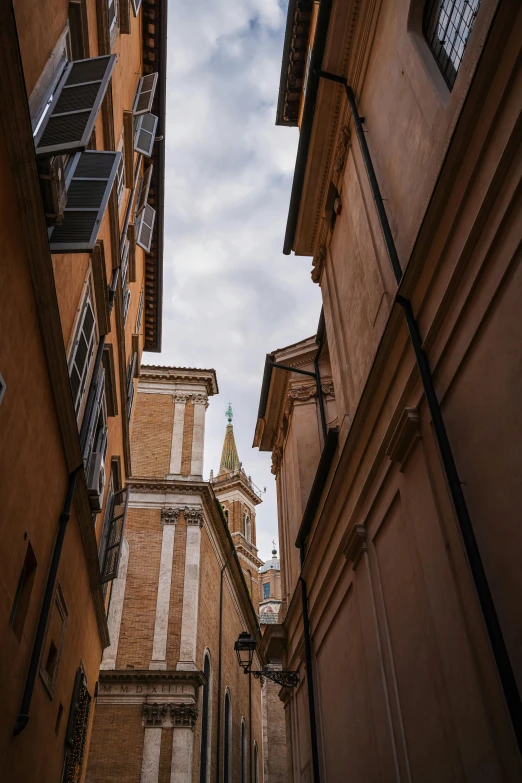 a narrow street leads to the tall buildings