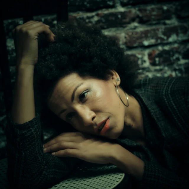 a woman leaning her head over the top of a stool