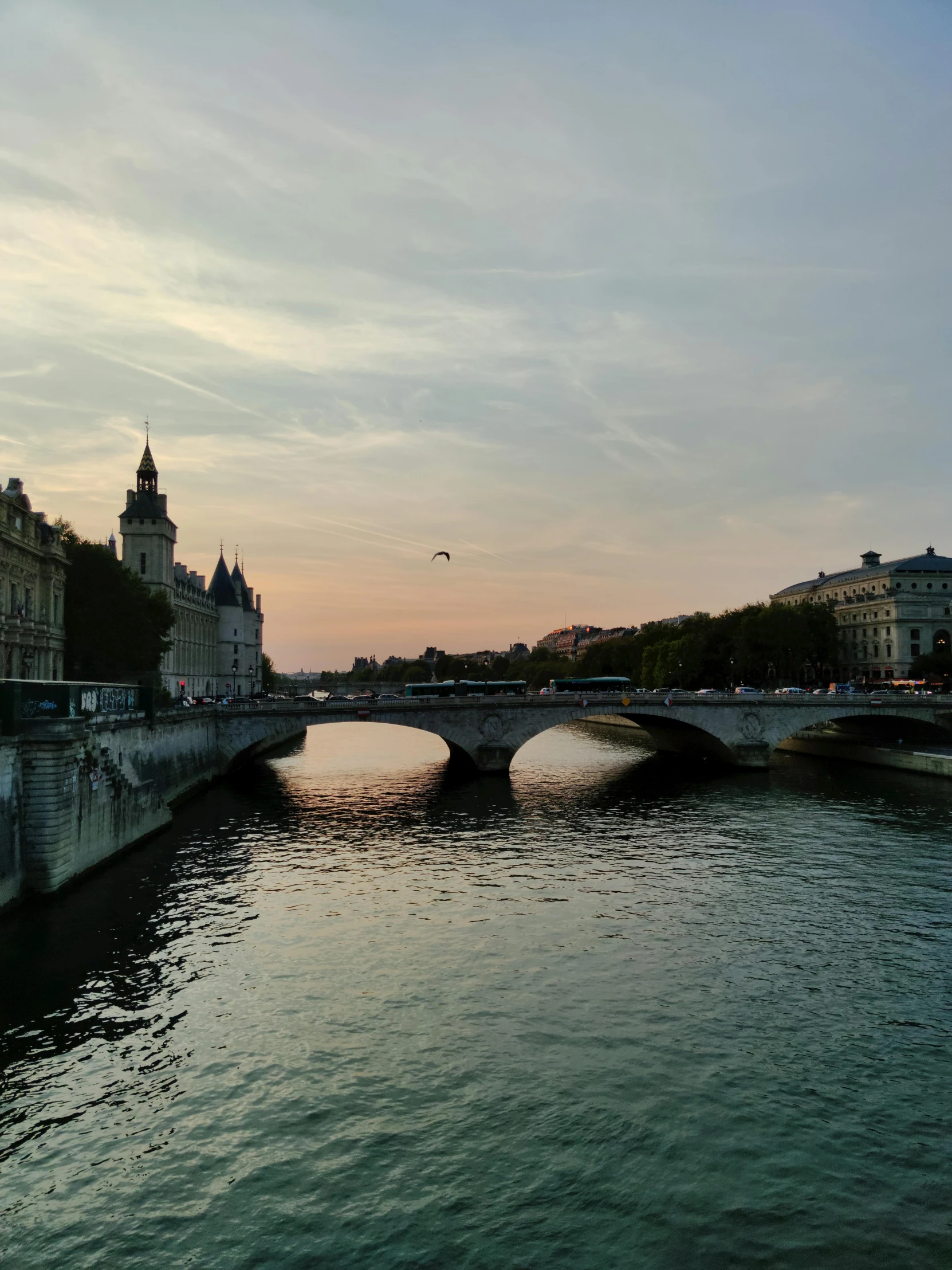 a bridge crosses a river in the early evening