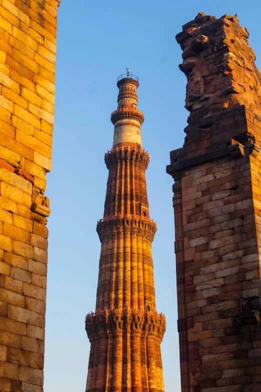 view of the top of a tall tower through two other towers