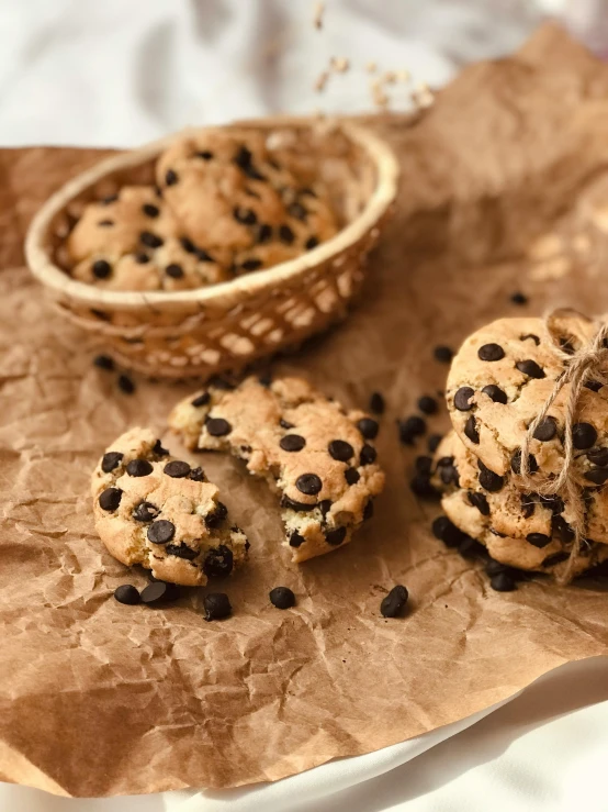 an arrangement of chocolate chip cookies sitting on top of paper