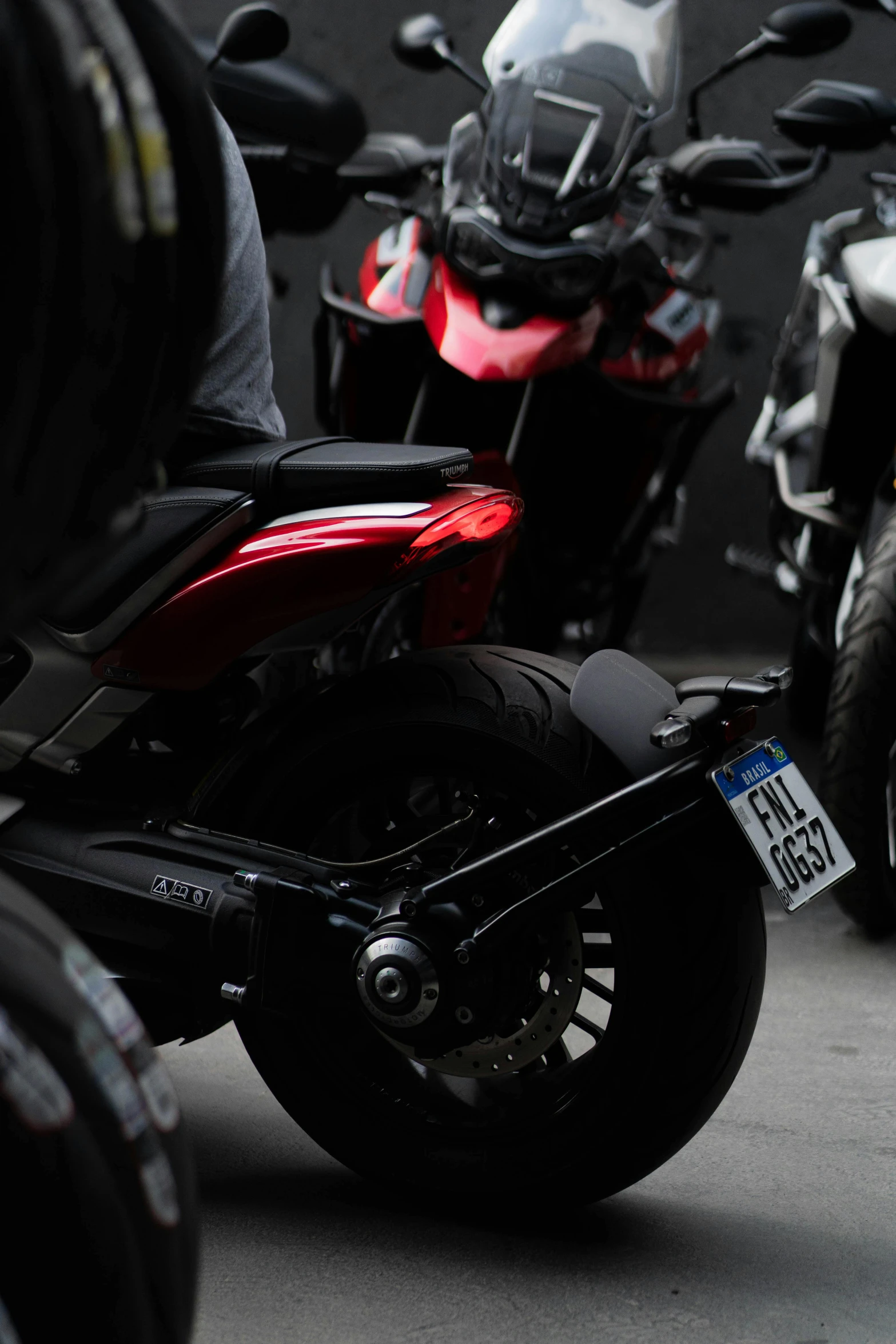 a motor cycle with a license plate parked next to some motorcycles