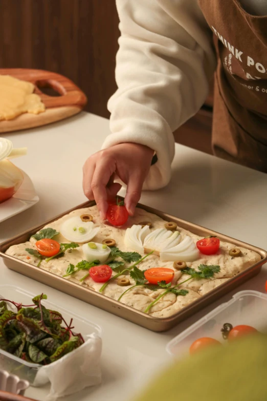 person reaching for food in container at table