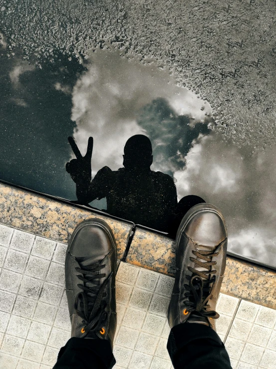 the feet of a person sitting in front of water