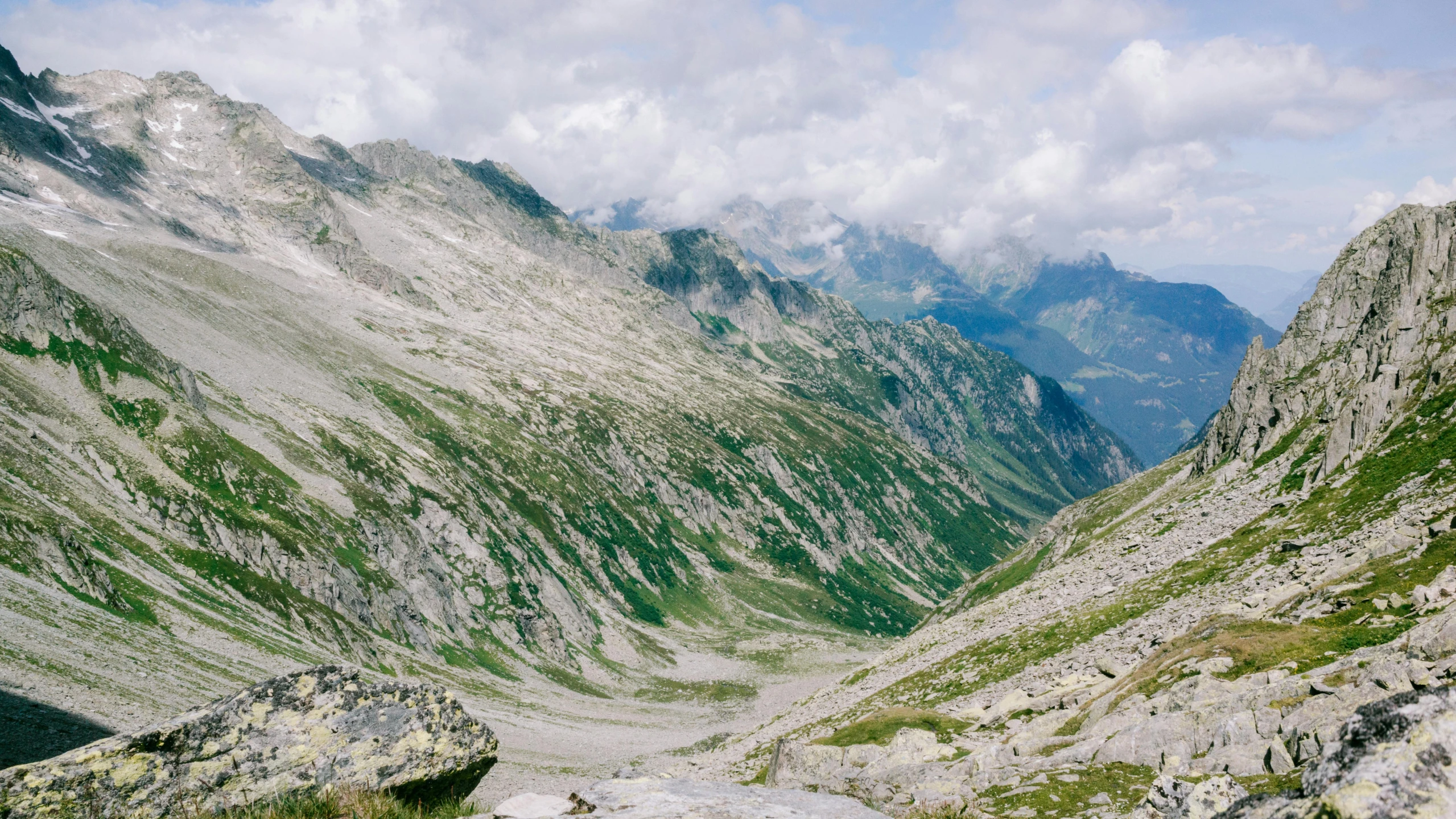 a scenic view of the mountains with a sky background