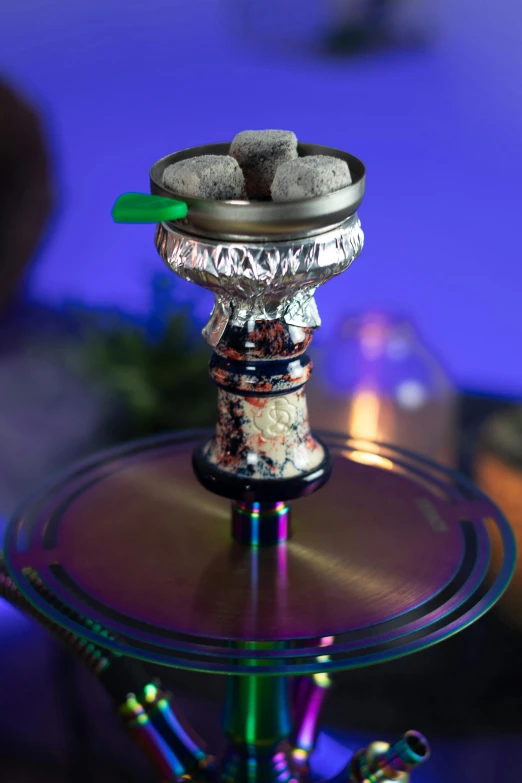 a bowl of rocks sits on top of a small metal stand