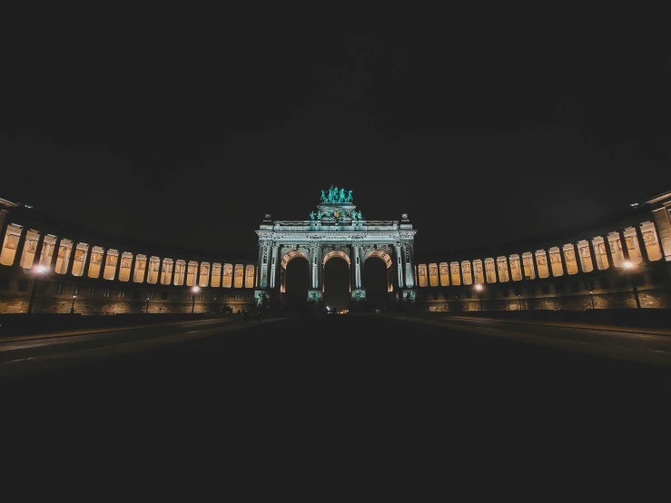 the gate to the arch has an illuminated clock at the top