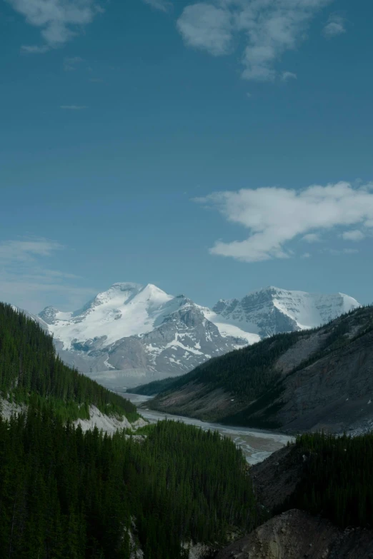 the landscape in a mountain range with a river below