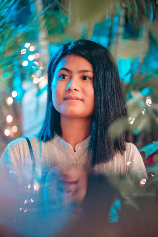 a close up of a person with lights in the background