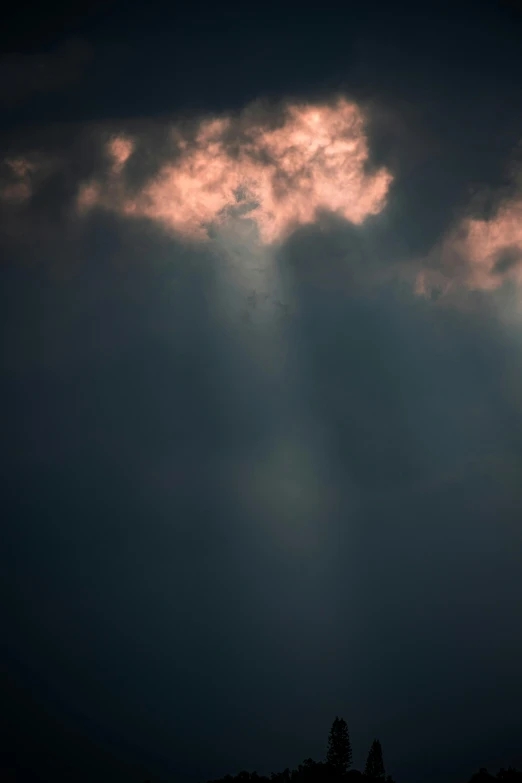 the sun peaking through clouds behind a large plane