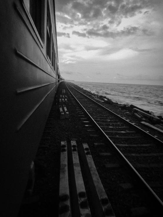 a train going on some tracks by the ocean