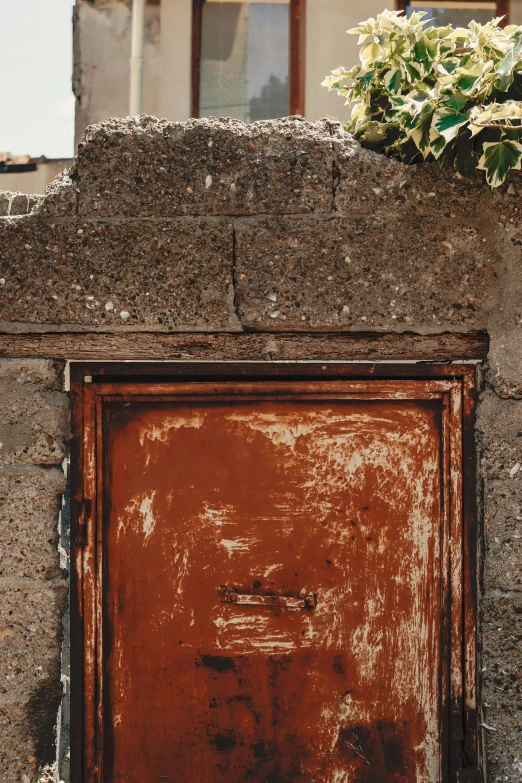 a rusted door with window on the side