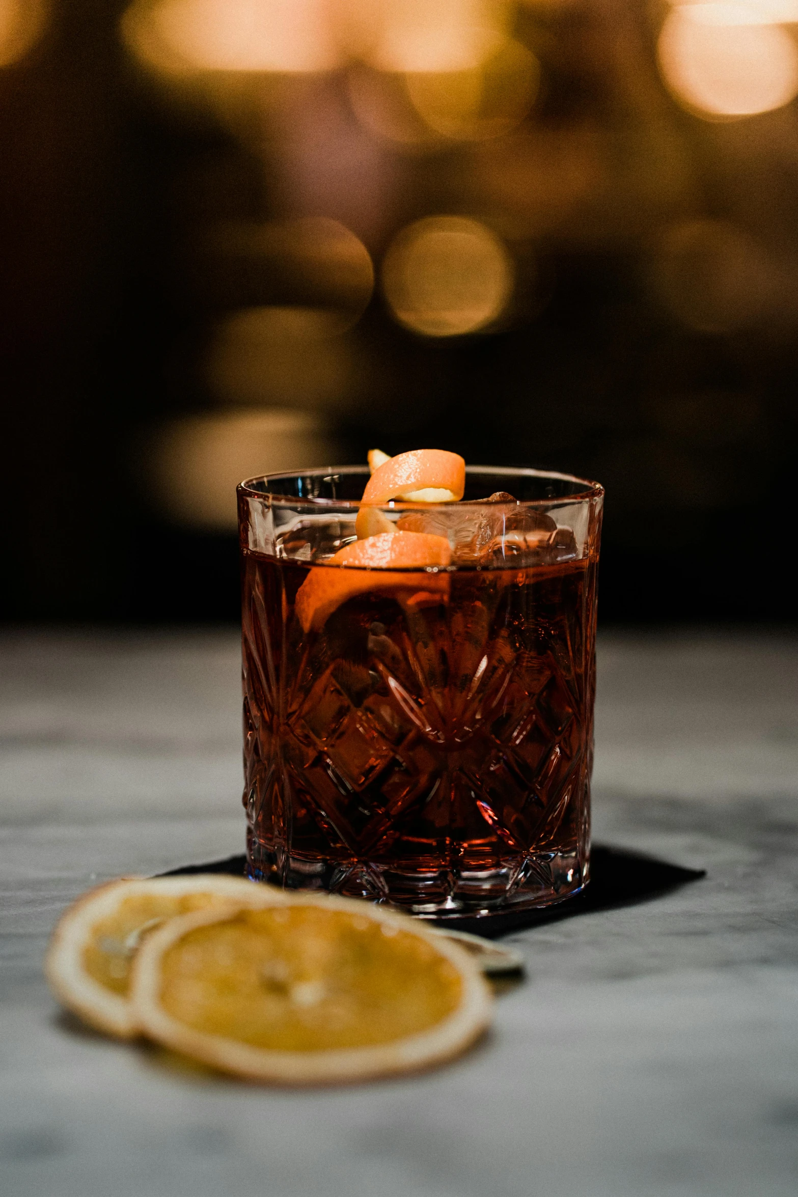 an orange slice is placed next to a cocktail