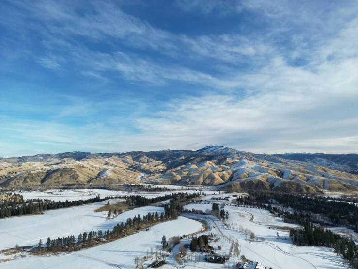 a large mountain with a few snow covered hills