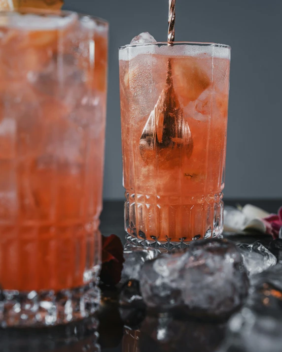 a glass of the same type of beverage on top of a table